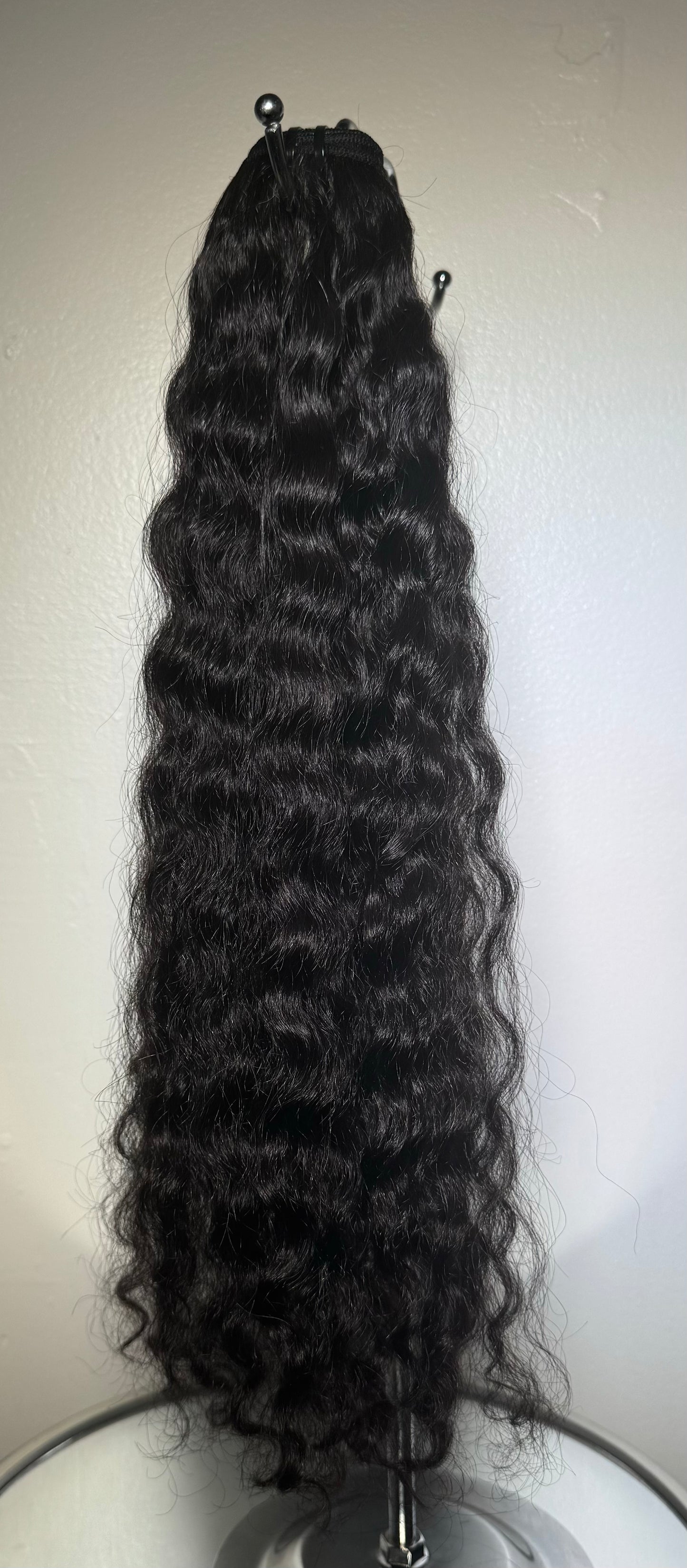 Premium curly hair extensions designed for longevity and durability, showcasing high-quality curls with natural bounce and shine. Extensions are available in various lengths and shades, crafted to withstand daily styling while maintaining their texture and volume. Ideal for customers seeking long-lasting, resilient curly hair extensions.